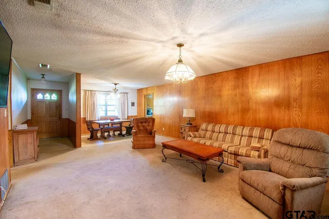 a living room with furniture and a chandelier