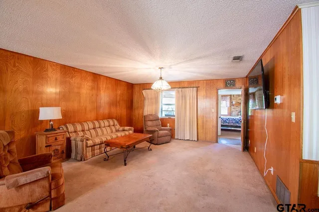a bedroom with furniture and a chandelier