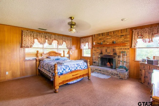 a bedroom with a bed and a fireplace