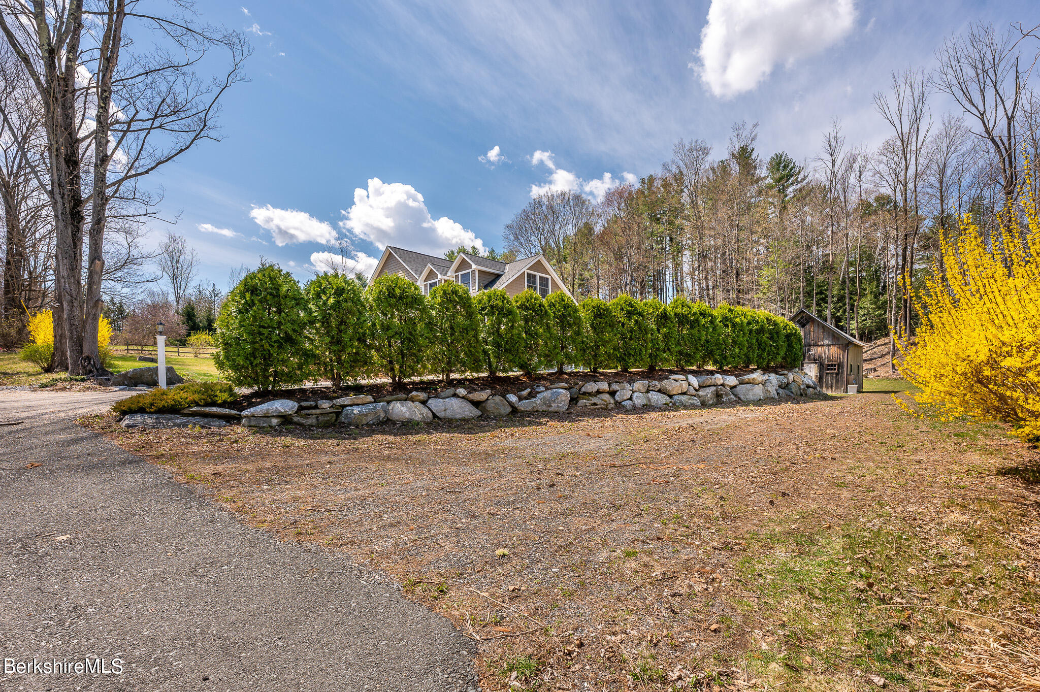 8 Castle Hill Road Stockbridge, MA 01262 - Photo 42 of 46 a front view of a house with a yard and a garage