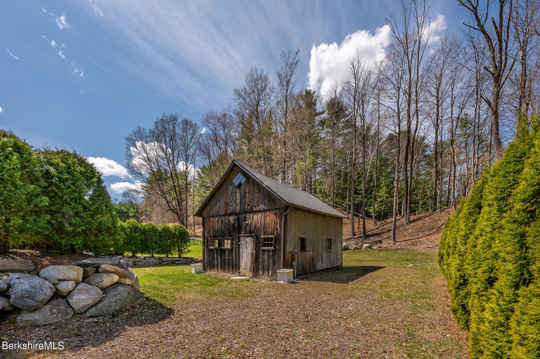 8 Castle Hill Road Stockbridge, MA 01262 - Photo 7 of 46 a view of a house with a yard and a wooden deck