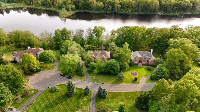 an aerial view of residential house with outdoor space and lake view