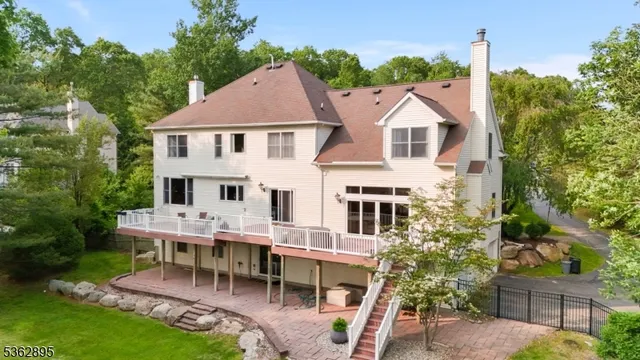 a aerial view of a house with a yard table and chairs