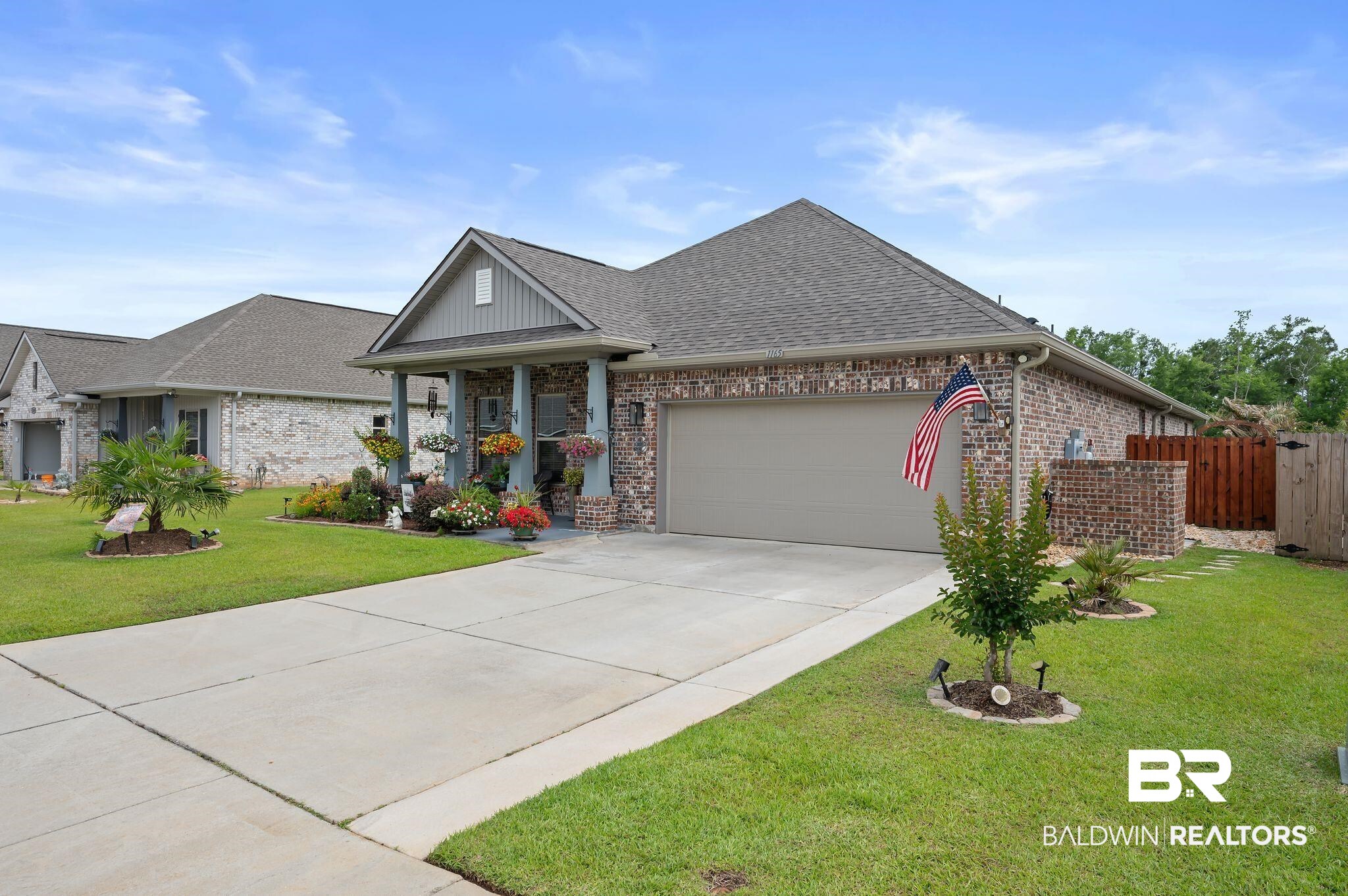 1165 Stella Road Foley, AL 36535 - Photo 42 of 42 View of front facade with brick siding, a garage, driveway, and a shingled roof