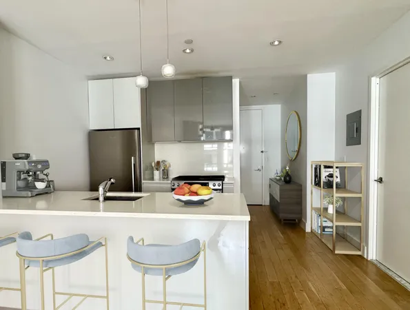 a kitchen with stainless steel appliances granite countertop a sink refrigerator and cabinets