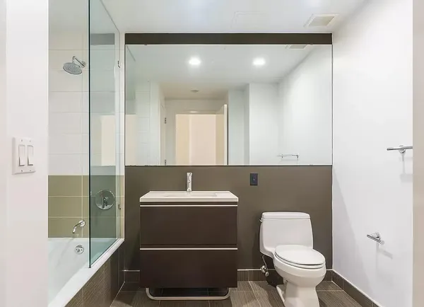 a bathroom with a toilet a sink and mirror