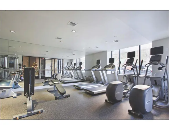 a living room with lots of gym equipment