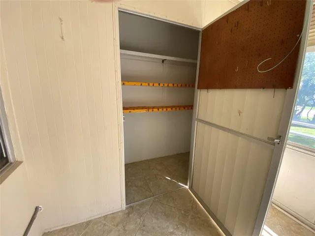 a view of a hallway with windows and entryway