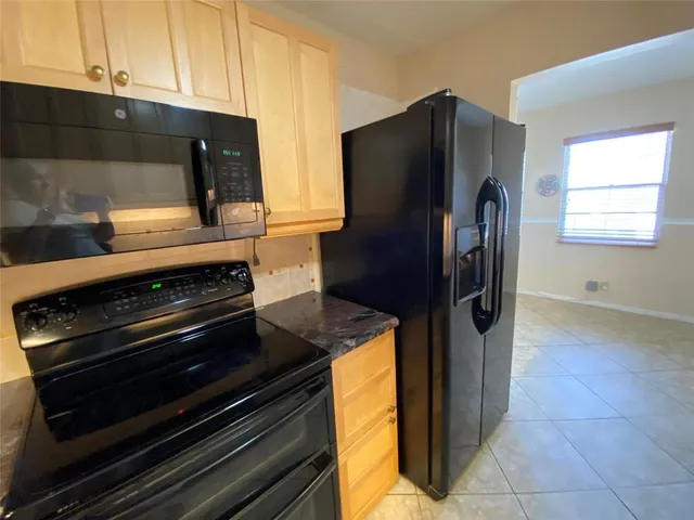 a kitchen with appliances and cabinets