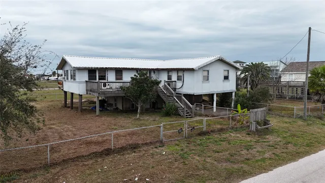 a view of a house with a backyard and porch