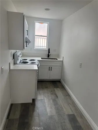 a kitchen with a sink cabinets and window