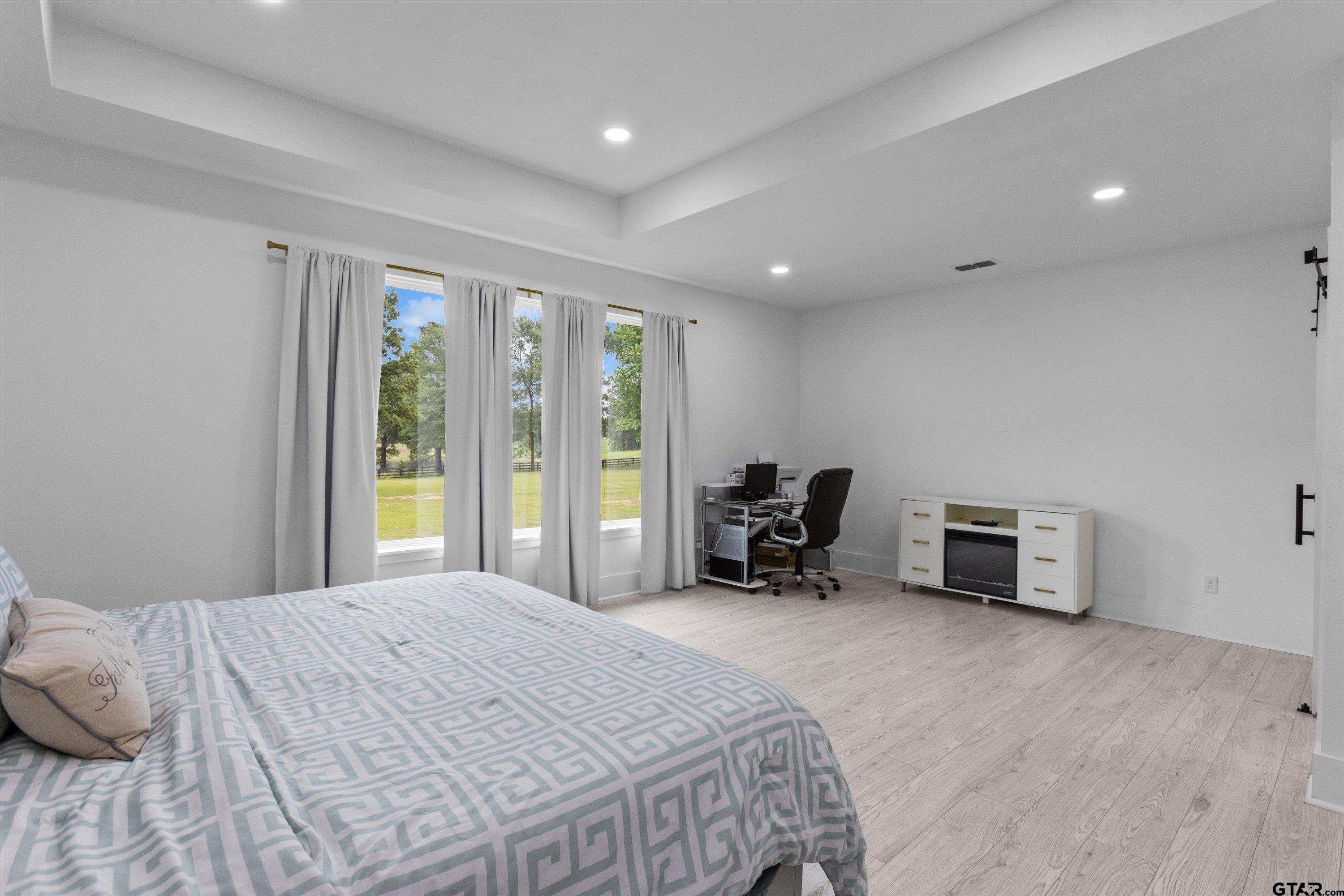 2680 Primera Road Tyler, TX 75705 - Photo 13 of 47 a spacious bedroom with a bed and a chair