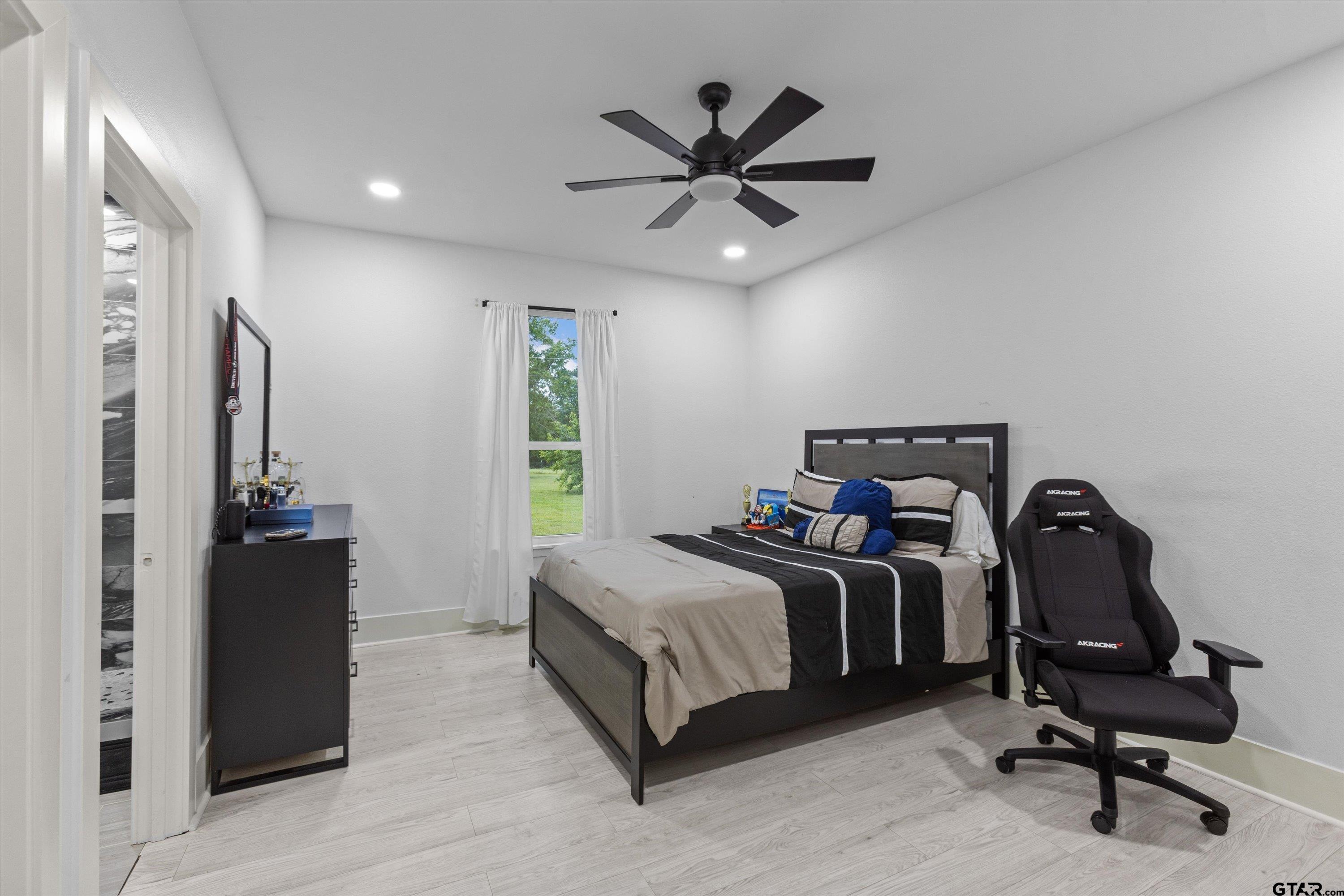 2680 Primera Road Tyler, TX 75705 - Photo 18 of 47 a bedroom with a bed and a ceiling fan