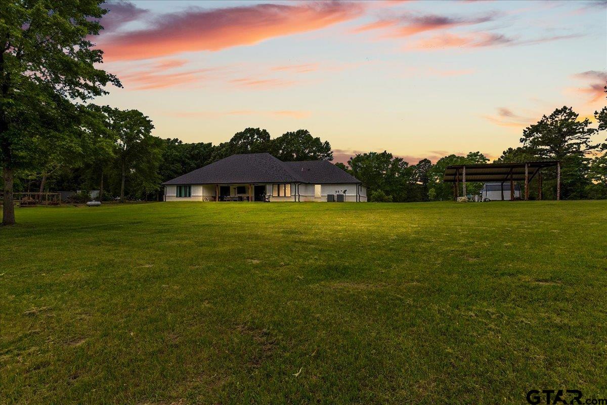 2680 Primera Road Tyler, TX 75705 - Photo 36 of 47 a view of a green field with an house in the background