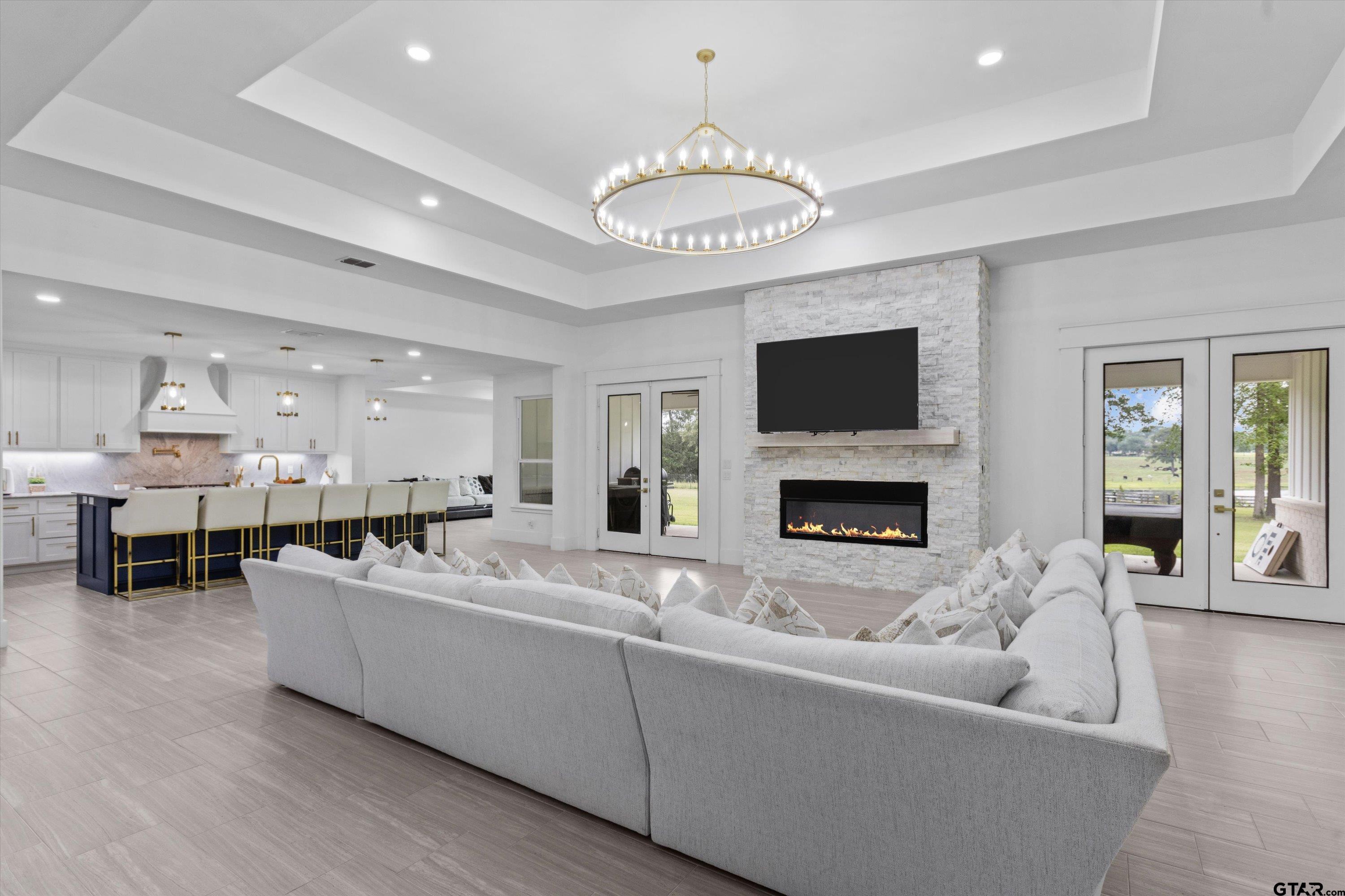 2680 Primera Road Tyler, TX 75705 - Photo 5 of 47 a living room with furniture a fireplace and a flat screen tv