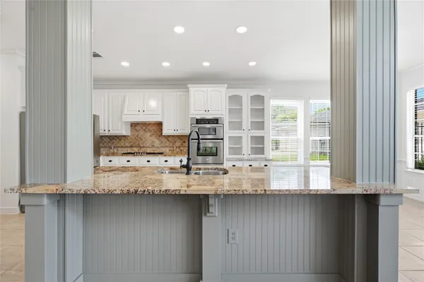 a spacious bathroom with a tub sink shower and mirror