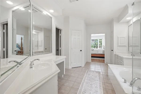 an empty room with a bathroom and a mirror