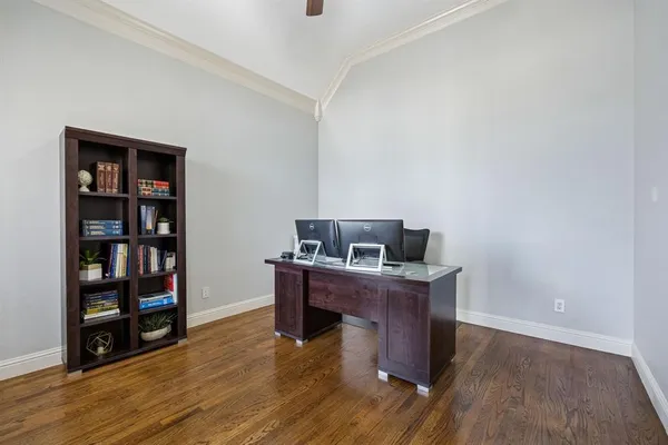 a view of a workspace with furniture and wooden floor