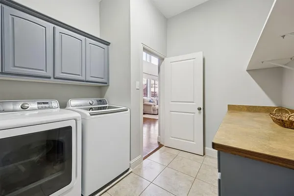 a kitchen with a stove sink and cabinets