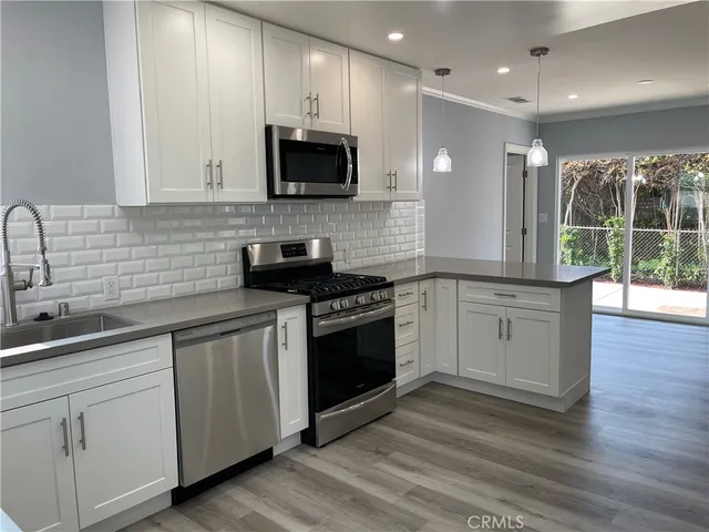 a kitchen with a sink stove and cabinets
