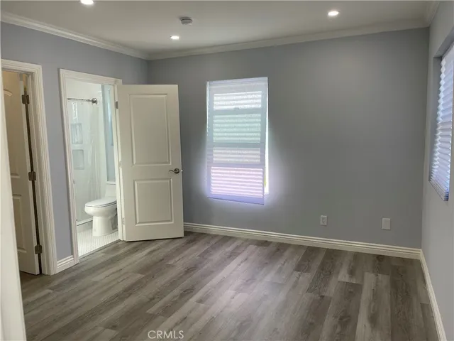 a view of wooden floor and windows in a room