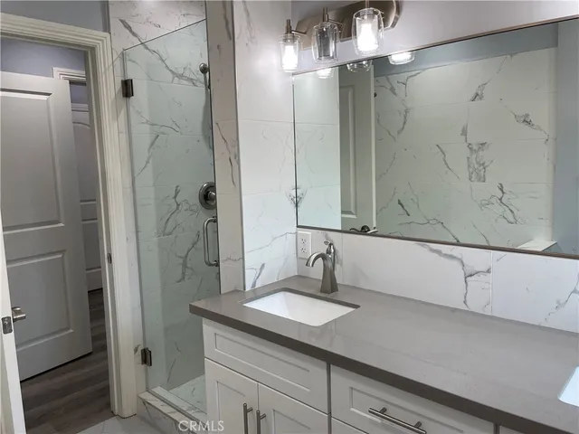 a bathroom with a shower and a sink