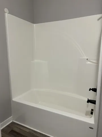 a bathroom with bathtub and shower