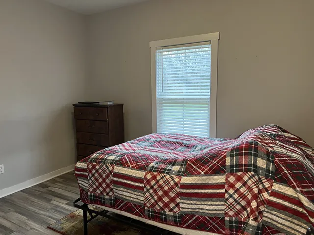 a bedroom with a bed and a window