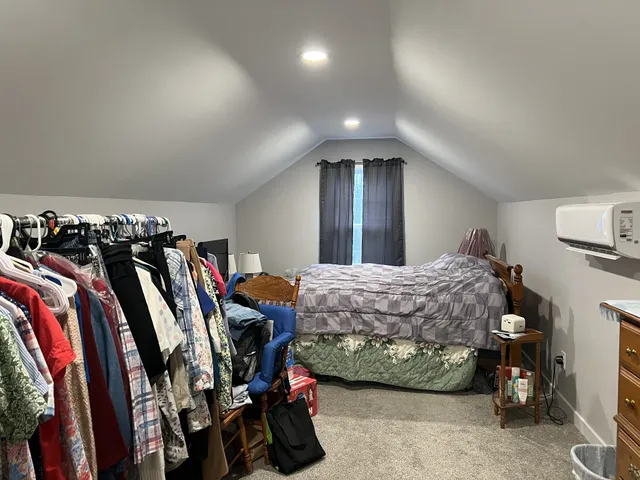 a bed room with a bed and a walk in closet