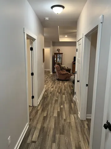 a view of a hallway view with wooden floor and furniture