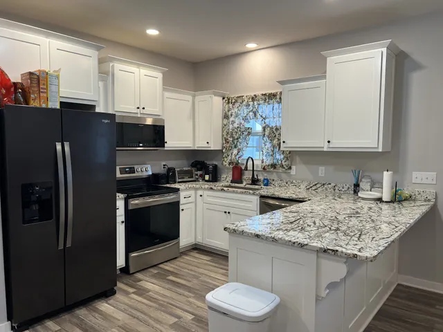 a kitchen with a sink stove and refrigerator