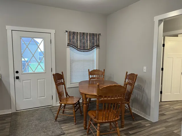 a view of a dining room with furniture and a window
