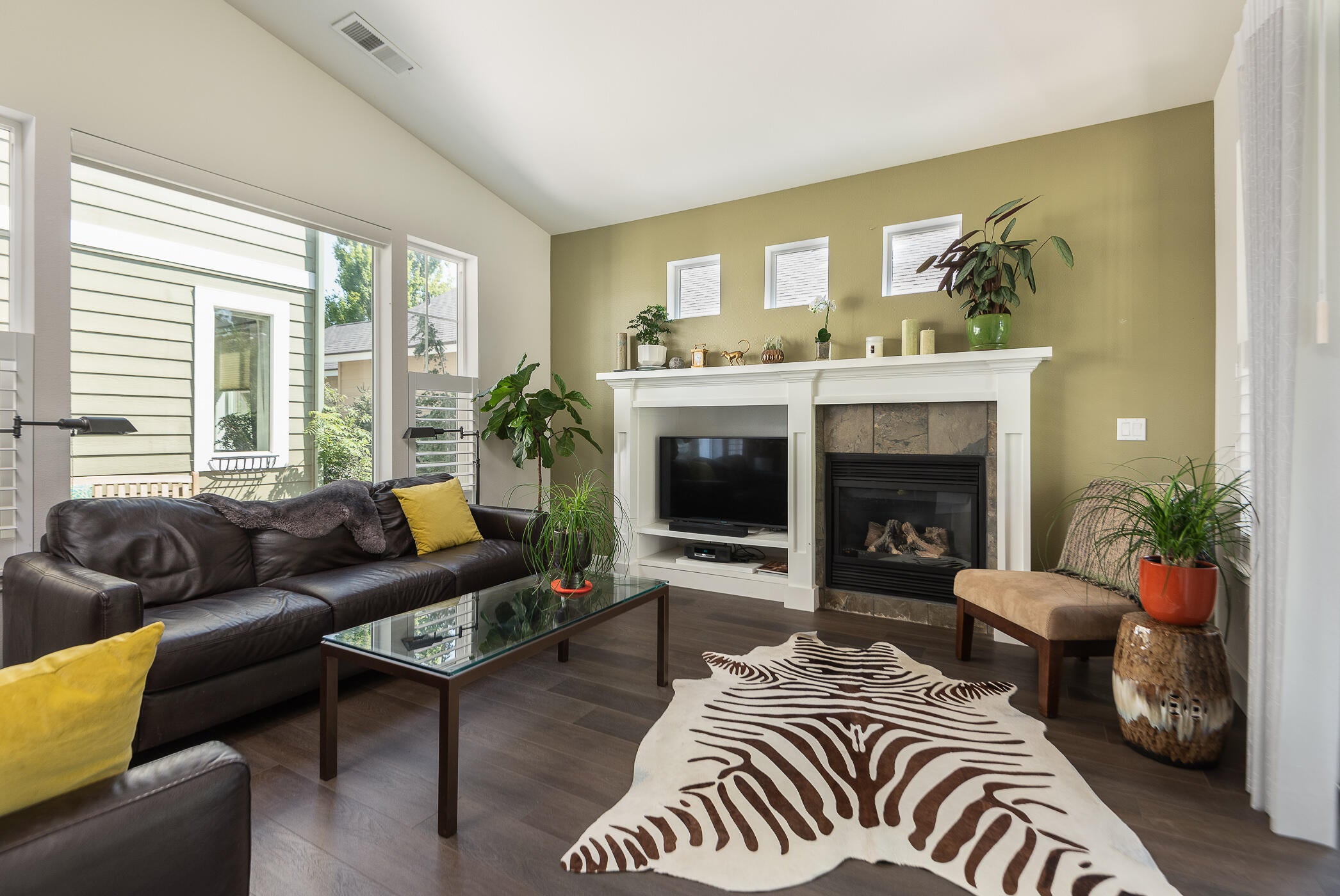 A gas fireplace is the focal point of the far wall, with a wall of windows looking into the courtyard.