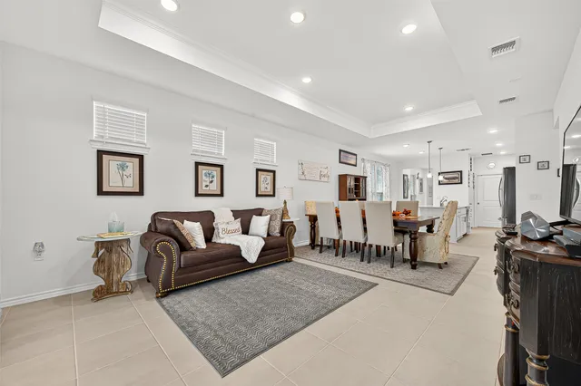 a living room with lots of furniture and a large window