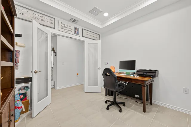 a view of a workspace with furniture and a window