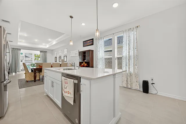 a kitchen with kitchen island a sink appliances and a counter top space