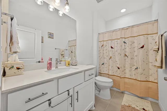 a bathroom with a sink a toilet and shower curtain