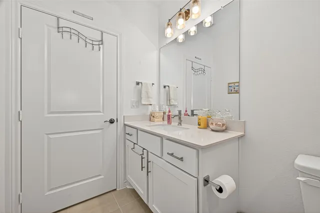 a bathroom with a sink a light fixture and a mirror