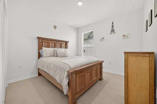 a spacious bedroom with a bed and a window