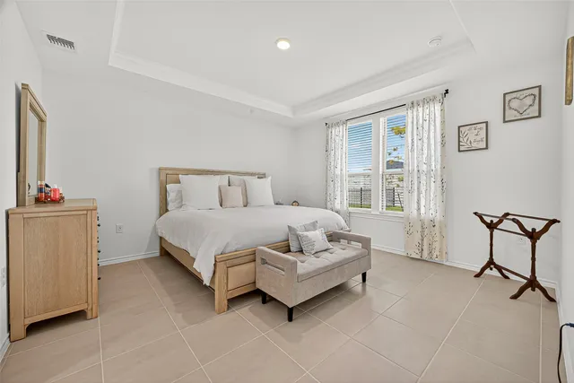 a bedroom with a bed chair and a window