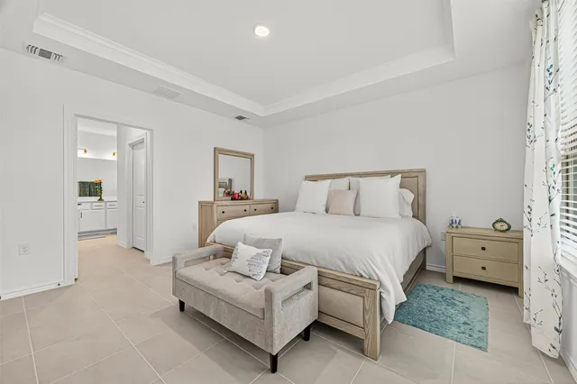 a bedroom with a bed and a couch