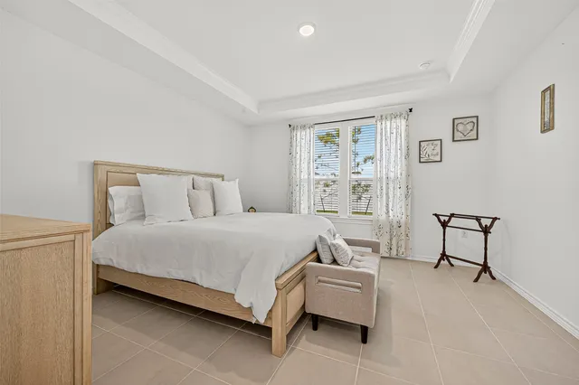 a bedroom with a bed chair and a window