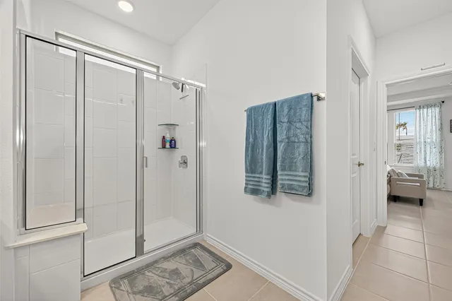 a bathroom with a shower and a glass door