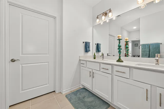a bathroom with a double vanity sink and a mirror