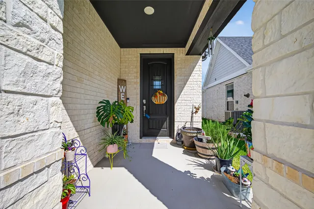 a house with potted plants in front of it