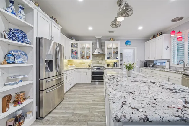 a kitchen with granite countertop stainless steel appliances and counter space