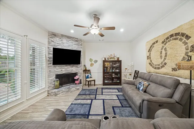 a living room with furniture a flat screen tv and a fireplace