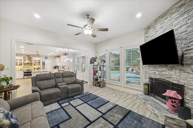 a living room with furniture a flat screen tv and a fireplace