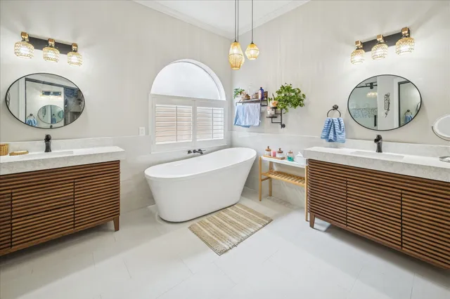 a bathroom with a two sinks a toilet and a mirror