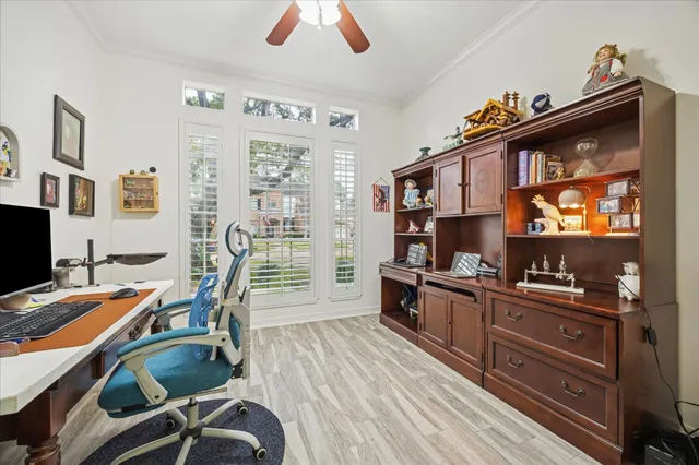 a view of a workspace with furniture and a flat screen tv